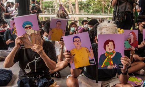 Protesters at Chulalongkorn University in Bangkok hold portraits of pro-democracy activists who were charged under the lese majeste law