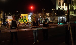 Ambulances and police emergency response teams work outside Buckingham Palace.