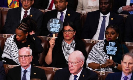 Woman holds up ‘stop sending bombs’ sign