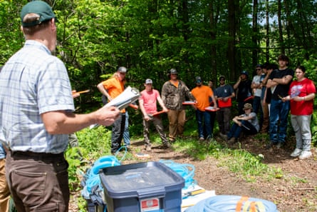 Mark Isselhardt, a maple extension officer with the University of Vermont, gives students directions for a timed challenge simulating part of the maple syrup tapping process in Randolph, Vermont, on 20 May 2024.
