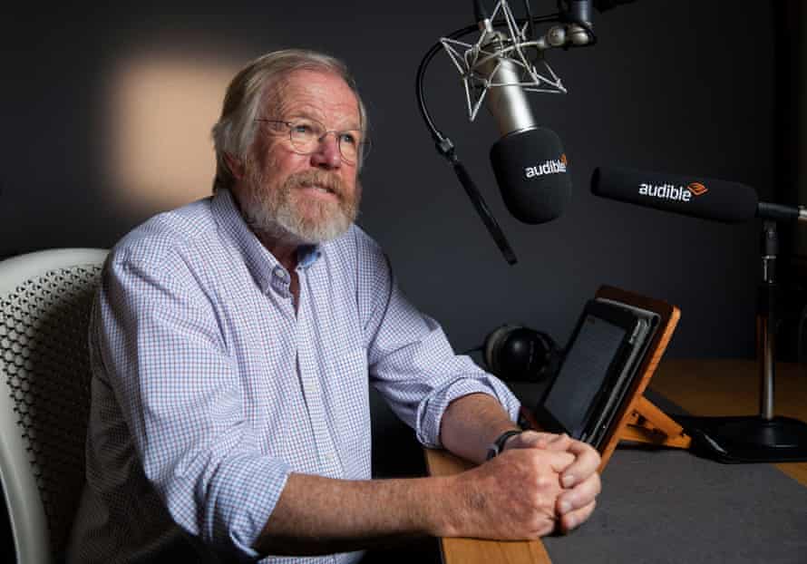 Author Bill Bryson sitting by a mic at the Audible audiobook studio