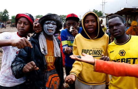 People hold rubber bullets and teargas canisters after a post-election protest