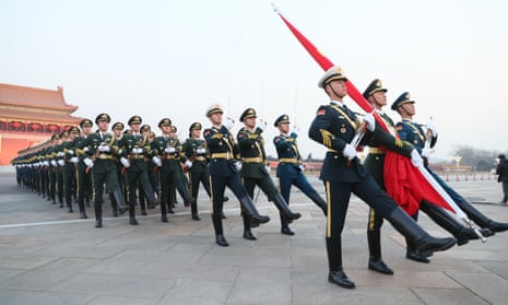 Chinese People’s Liberation Army (PLA) members march to the flagpole during a flag-raising ceremony at the Tiananmen Square