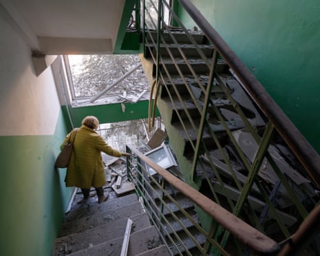 An elderly woman walks to inspect her damaged flat at the site of a Russian missile strike on a nine-storey residential building in Kyiv, Ukraine.