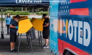People vote at a voting station for the special election between the Democratic state assemblywoman Christy Smith and Republican businessman and ex-navy pilot Mike Garcia, in Santa Clarita, California.