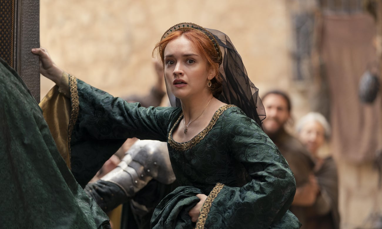 Still from House of the Dragon. Olivia Cooke as Alicent Hightowever wearing a green dress and veil with a panicked expression
