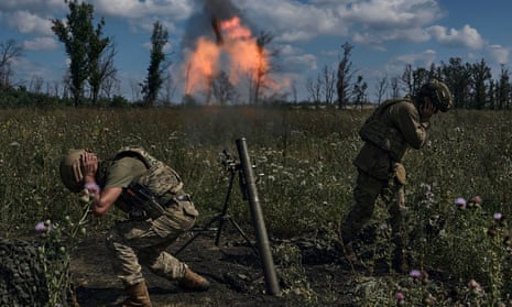 Ukrainian soldiers fire a mortar towards Russian positions near Bakhmut, Donetsk region.