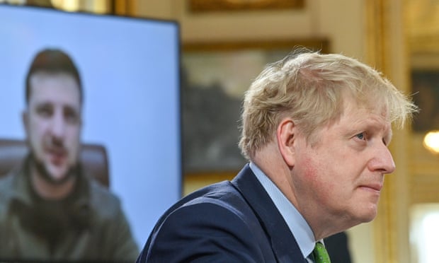Boris Johnson listens as Ukrainian president Volodymyr Zelenskiy addresses by video link leaders attending a summit of the Joint Expeditionary Force (JEF) in London on 15 March.