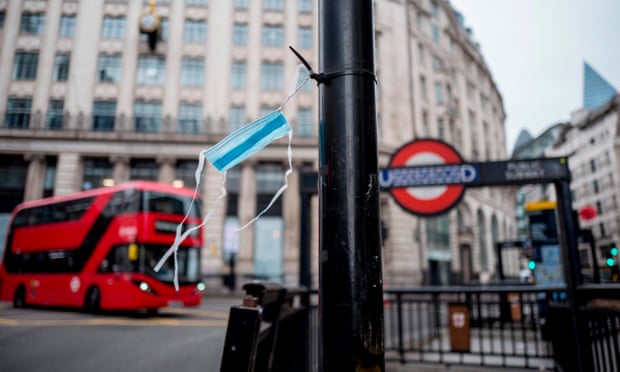 A surgical mask hangs on a lamppost in central London as people take precautions amid the novel coronavirus outbreak.