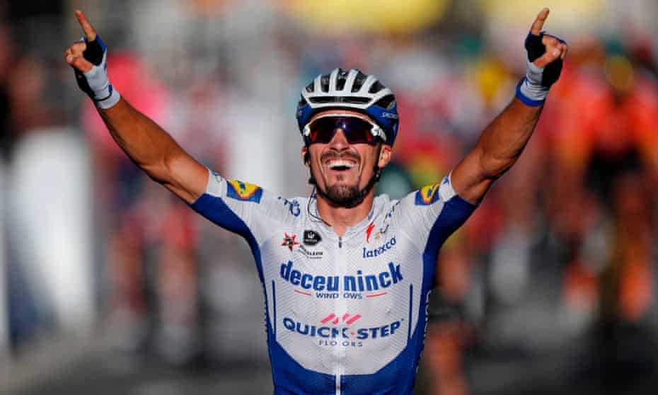 Julian Alaphilippe celebrates as he crosses the finish line to win.