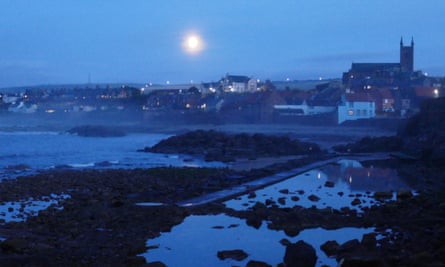 A full moon rises over Dunbar.