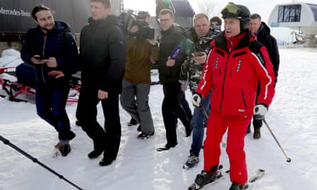 Vladimir Putin in skiing gear surrounded by reporters