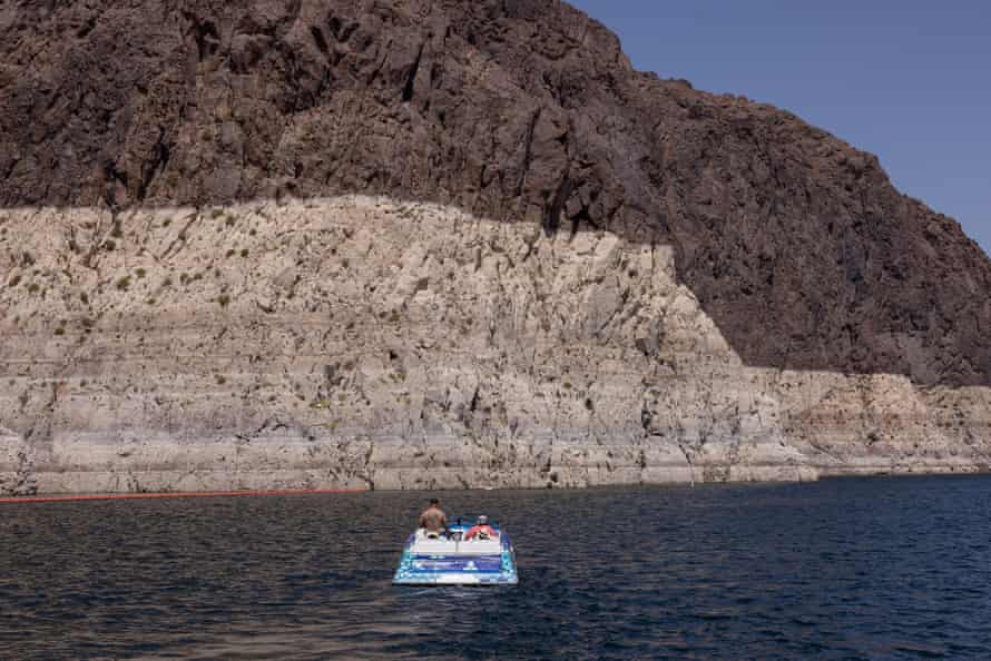Boaters look at the growing ring around Lake Mead.