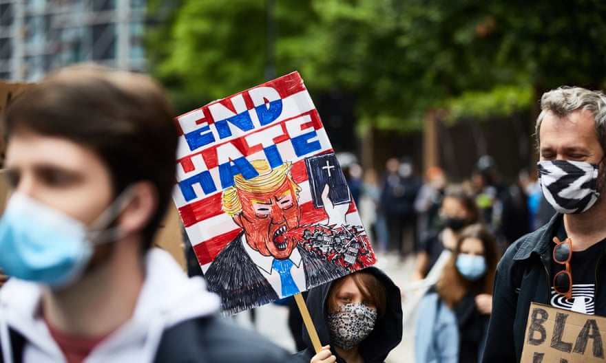 A protester holds a placard showing Donald Trump at a Black Lives Matter protest outside the US Embassy in London on 7 Jun 2020