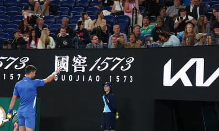 Novak Djokovic points to a spectator during his second-round defeat of Alexei Popyrin.
