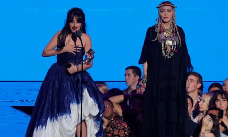 Camila Cabello accepts the video of the year award next to Madonna.