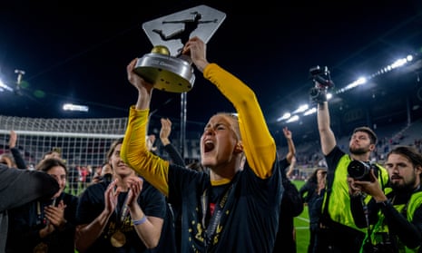 Bella Bixby lifts the NWSL trophy after Portland Thorns defeated Kansas City Current in the 2022 final.