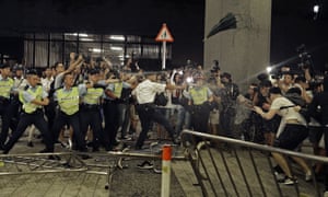 Police officers use pepper spray against protesters in Hong Kong