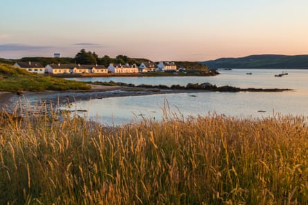 A row of white houses along a bay on a sunny evening