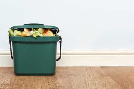 A kitchen caddy filled with food waste