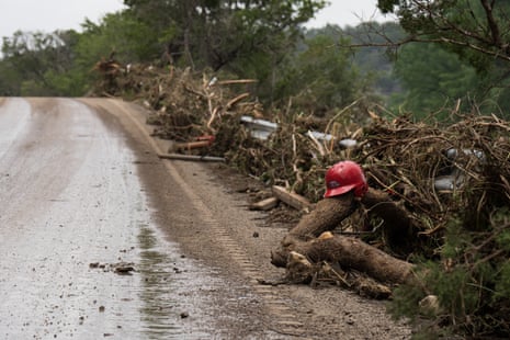 A child's baseball helmet lies among flood debris along TX-39 near Hunt, Texas.