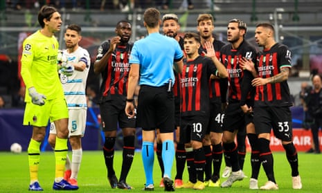 Milan players surround the referee, Daniel Sieber, after he sent off Fikayo Tomori in the Champions League game against Chelsea.