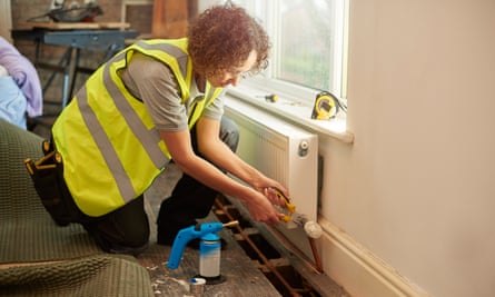 Plumber installing a new radiator