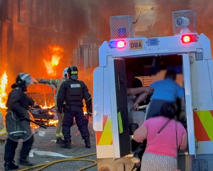 Belfast residents run from burning homes as violence erupts after protests – video