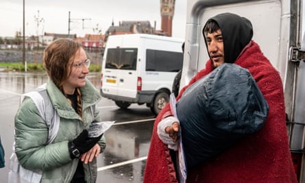 The 22-year-old Syrian migrant Badr receives a tent and bags from volunteers with Care4Calais.