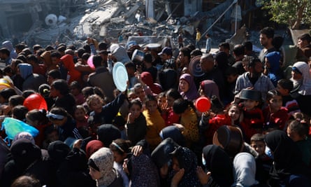 Palestinians queue for food