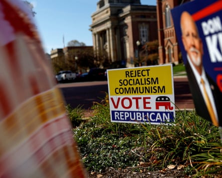 A yellow sign reading âÂÂReject Socialism Communism, Vote Republicanâ stands outside an elections office