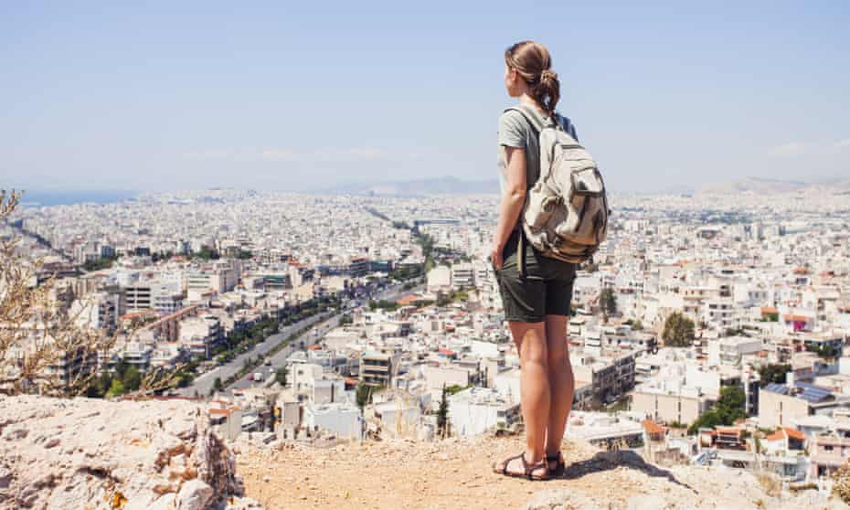 Young woman traveler looking on a city