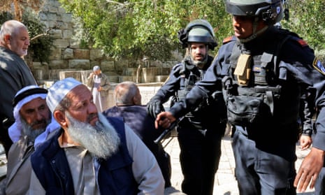 Israeli security forces speaking to Palestinian men