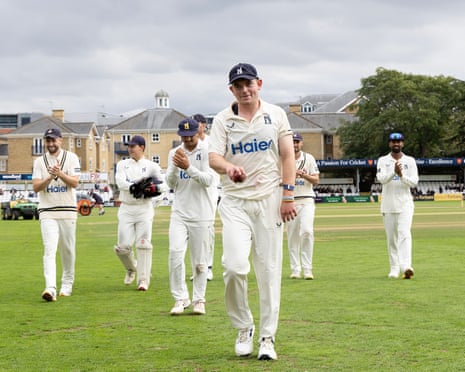 Ethan Bamber leads his team mates from the field following his six wicket haul