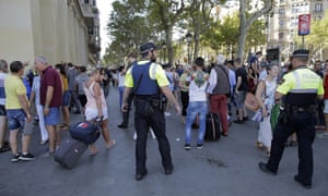 Police officers tell members of the public to leave the scene.