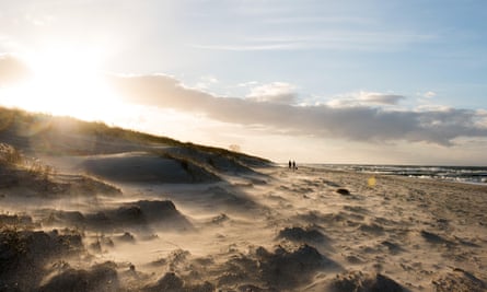 Walkers on a beach at the Baltic Sea near Ahrenshoop, Germany, 23 December 2015.