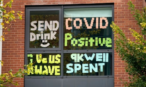 Signs made by locked-down students in Manchester, reading "send drink", "Covid positive", "Give us a wave" and "9k well spent"