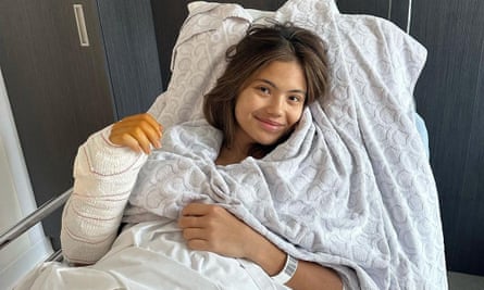 Emma Raducanu waves from a bed after wrist surgery