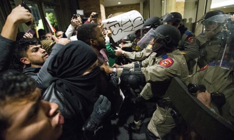 Law enforcement officers push protesters out of the Texas A&amp;M University student center where Richard Spencer, who leads a white nationalist organization, was speaking on Tuesday.