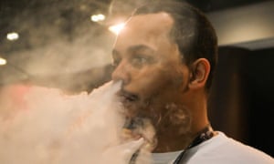 A man exhales after vaping at the Vape Jam Convention in London in April 2018.