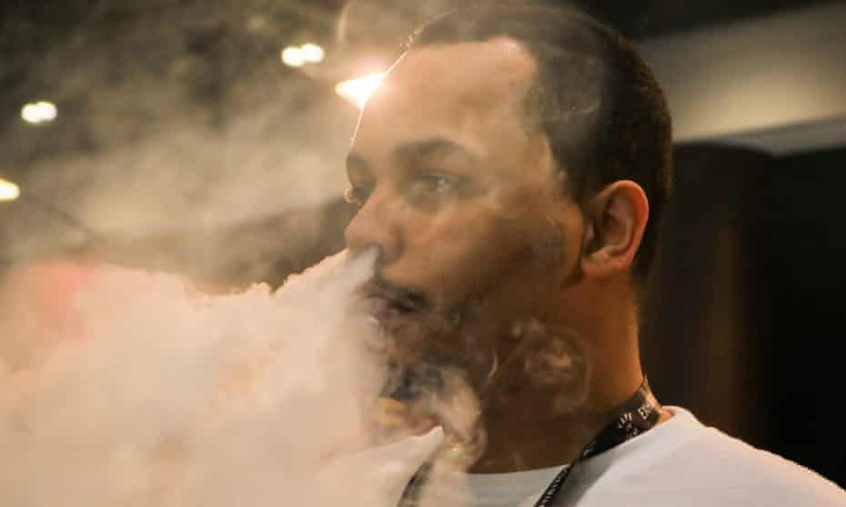 A man exhales after vaping at the Vape Jam Convention in London in April 2018. 