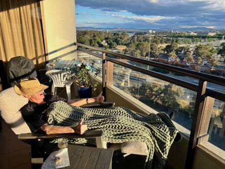 Alan Nicolle on a recliner on a balcony