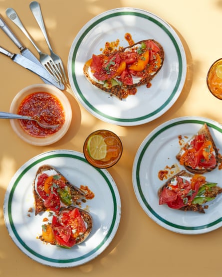 Thomasina Miers’ grilled tomato toasts with smoky sesame-harissa salsa.