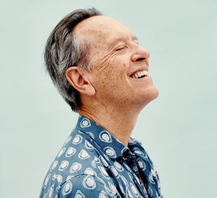 Richard E Grant in blue patterned shirt against blue background