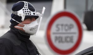 A Czech police officer during sanitary checks on drivers at the border crossing between Germany and Czech Republic.