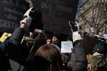 students hold signs outside