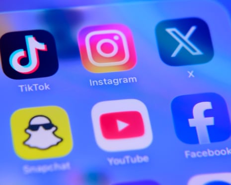 A folder of social media applications, including TikTok, Instagram, X (formerly Twitter), Snapchat, YouTube, and Facebook, is displayed on a smartphone screen in Creteil, France.