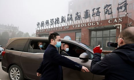 A WHO team visiting the Wuhan Institute of Virology in February last year. The question of where Covid came from and how it spread has proved divisive.