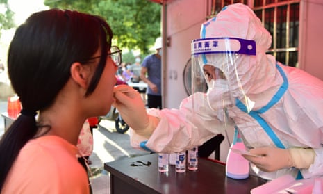 A health worker collects swab sample from a resident for Covid-19 test in China's Fujian Province
