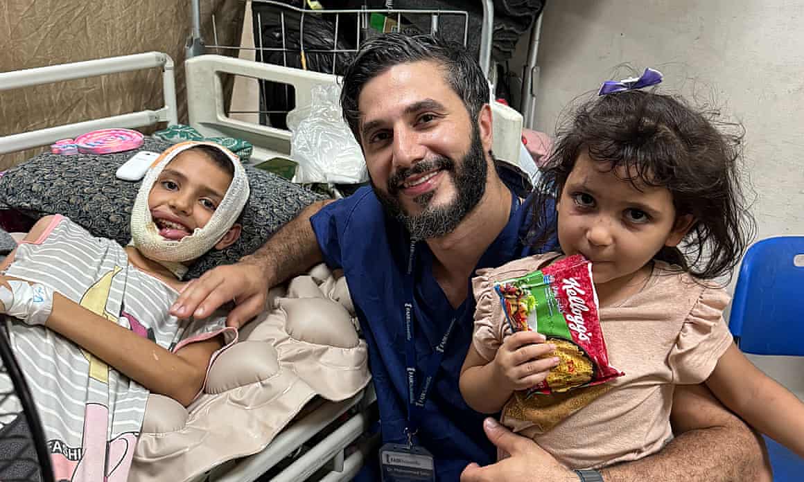 Mazyouna Damoo with a volunteer British doctor, Mohammed Tahir, and another child